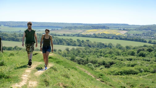 Two people walking at Stockbridge Down, Hampshire in the summer